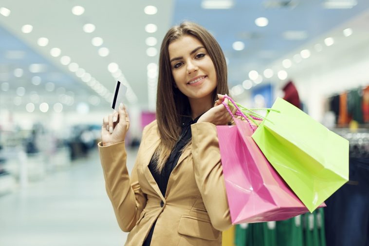 young-woman-with-credit-card-and-shopping-bag-758x505